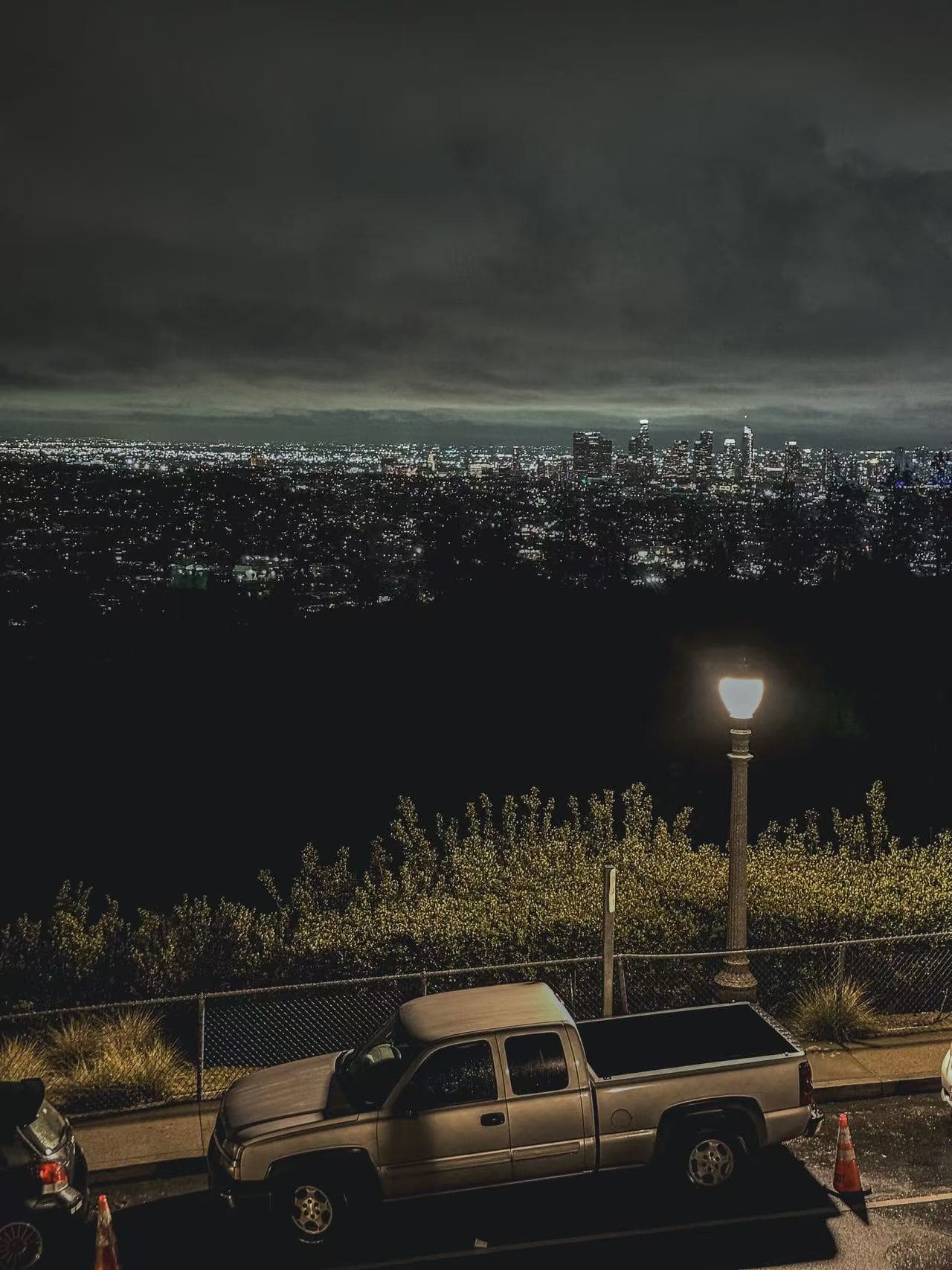 City lights seen from a hillside overlook at night